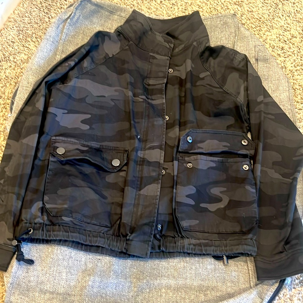 Democracy size small camo Jean jacket with two large pockets in the front.